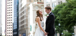 bride and groom outside holding hands